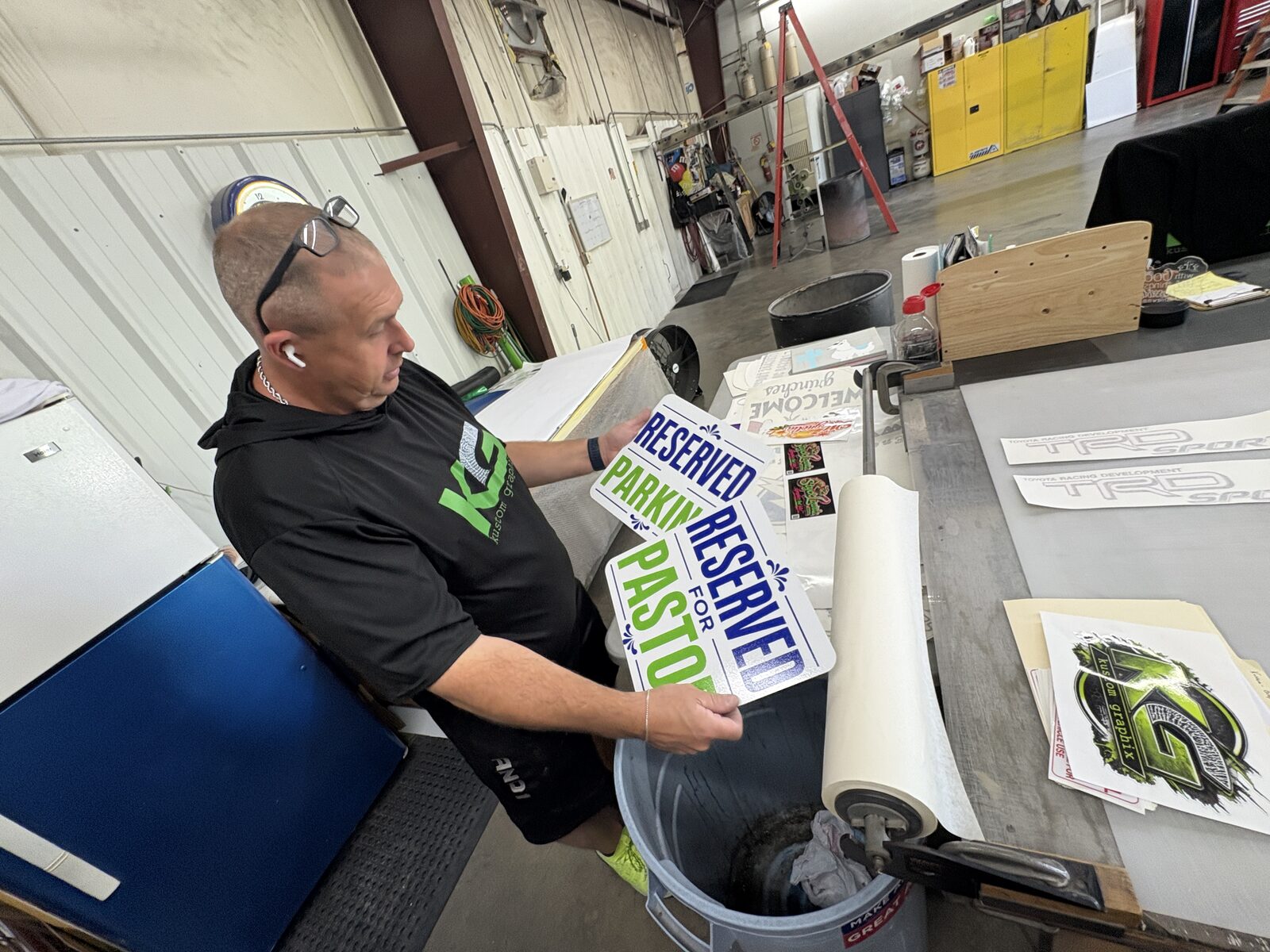 Applying vinyl lettering to a sign panel